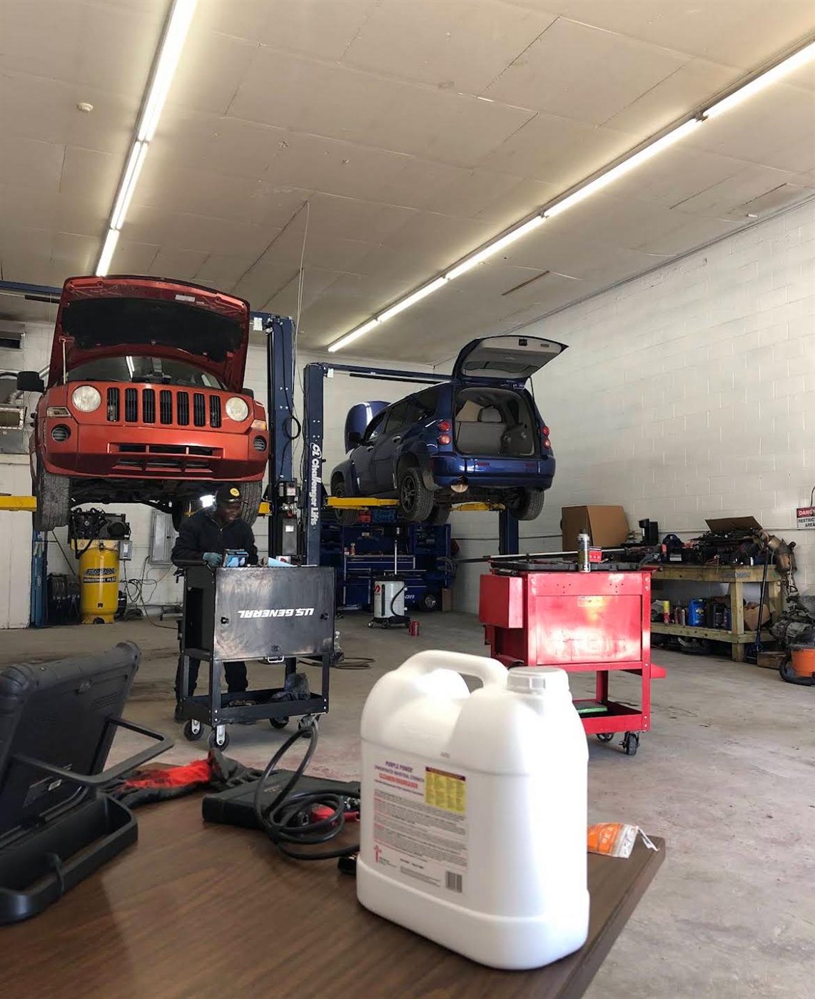 Cars up on the lifts inside the Avon Auto & Diesel shop
